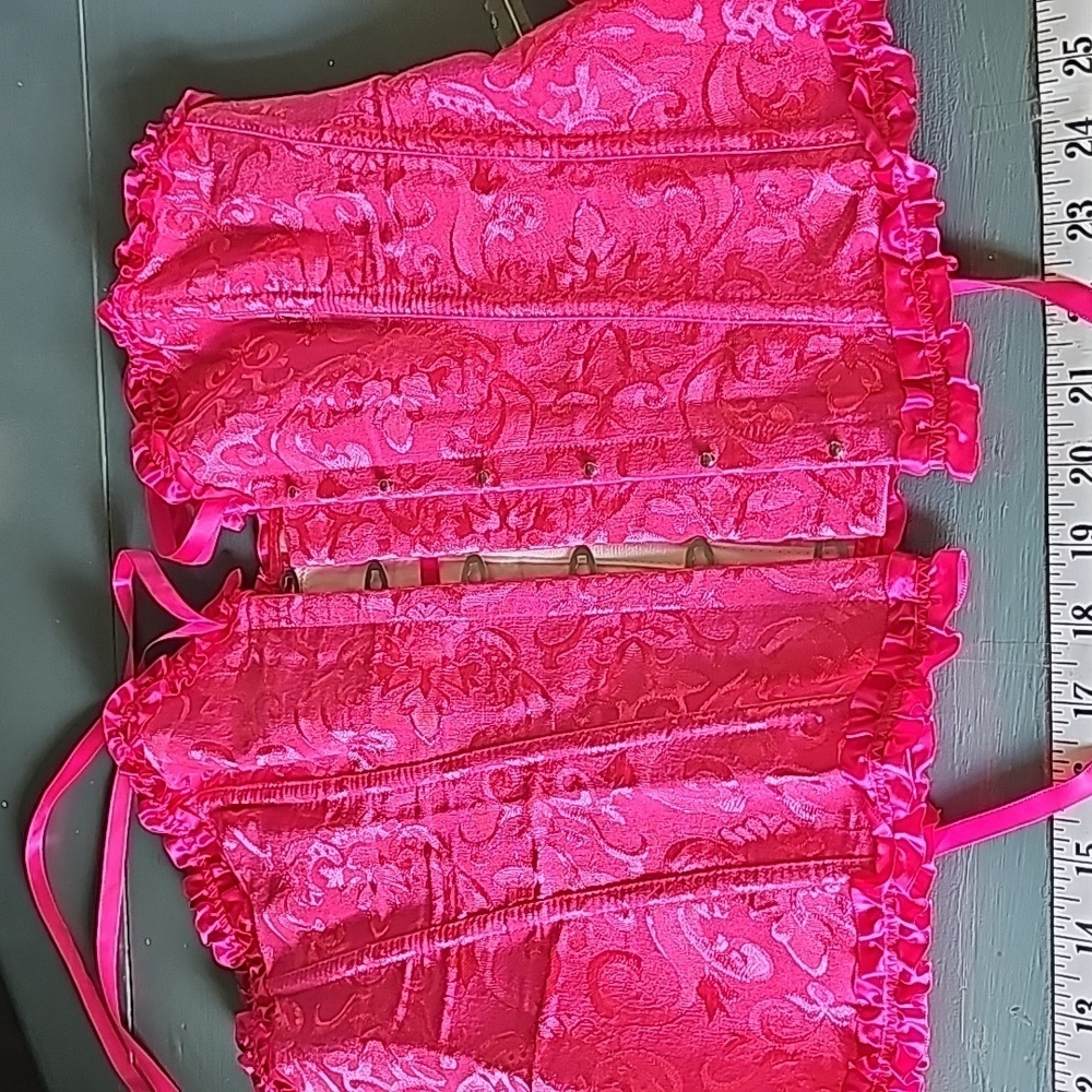 Pink satin corset. Snap closure on the other side. Lace up intact. Very good 2XL